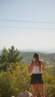 A woman is enjoying a breathtaking scenic view surrounded by nature, embracing tranquility video