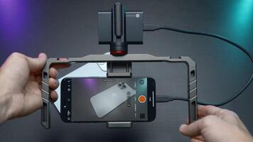 China, Beijing - September 15, 2023. Holder for shooting with stabilization for phone. Action. Professional stabilizer for phone and shooting. Samsung Stabilizer with new iPhone 15 pro for video