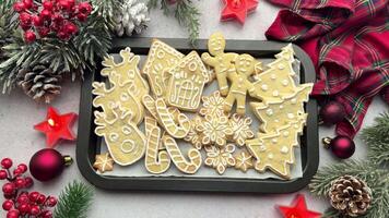 Christmas cookies displayed on baking sheet surrounded by holiday decorations video