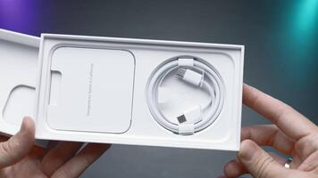 USA, New York - September 15, 2023. Unpacking iPhone 15 pro. Action. Configuration and analysis of new iPhone 15 pro max. Unpacking box of new iPhone 15 pro on isolated background for promotional video