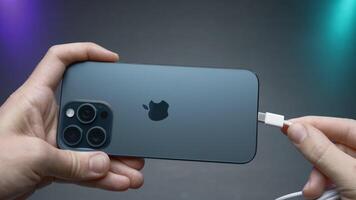 China, Beijing - September 15, 2023.Wire type C in new iPhone. Action. USB-C connector in new iPhone model 15 pro. Flagship in world of iPhones with new Type C charging connector in model 15 pro video