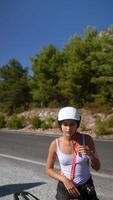 A daring and adventurous biker enjoys the beauty of a stunning scenic roadside view, video
