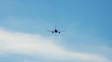 The journey begins, plane flies high in the cloudy sky. Jet airplane flying overhead in clear blue sky and leaving nice contrail. Plane smoothly as it flies through the sky video