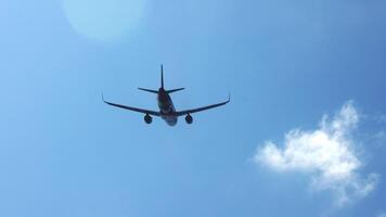 The journey begins, plane flies high in the cloudy sky. Jet airplane flying overhead in clear blue sky and leaving nice contrail. Plane smoothly as it flies through the sky video