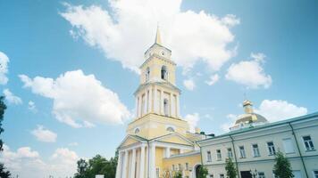 Low angle view of yellow Cathedral building on a blue cloudy summer sky background. Clip. Orthodox architecture theme. video