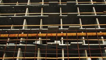 Facade of multi-storey concrete building under construction. Concept. View from below of multi-storey building under construction. Concrete building under construction on sunny day video