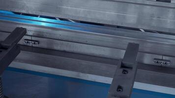 A metal sheet placed on a machine that folds it slowly. Creative. Automated metal folding and bending machine. video