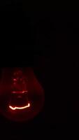 A Glowing Red Light Bulb Brightly Illuminating a Dark Setting for an Intimate Atmosphere. Stock Clip video