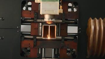 Industrial Laser cutting the edge of a square shaped pipe. Creative. Automated Industrial machine, close up view. video