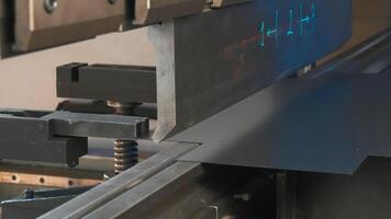 A metal sheet placed on a machine that folds it slowly. Creative. Automated metal folding and bending machine. video