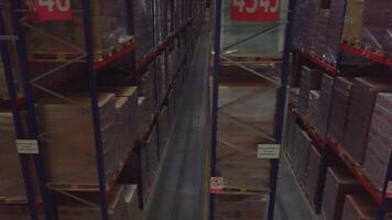 Warehouse with cardboard boxes inside on pallets racks, logistic center. Creative, Huge, large modern warehouse. video