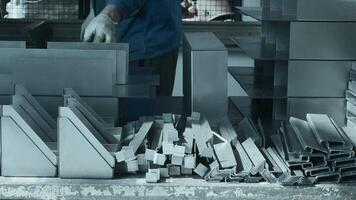 Worker manually assembles machine with metal parts. Creative. Work at factory for collection of metal structures and machine tools. Worker collects lot of metal parts at factory video