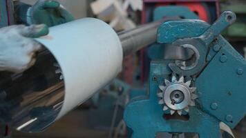 Metal rolling machine working in industrial workshop. Creative. Worker at a factory by a metal rolling machine bending a steel sheet. video