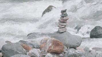 Harmony, balance and simplicity concept. Creative. A stone pyramid on the background of river water. video