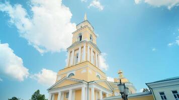 Low angle view of yellow Cathedral building on a blue cloudy summer sky background. Orthodox architecture theme. video