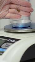 A shows precise weighing of objects on a scale video