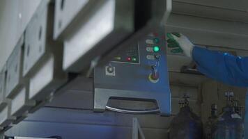 Details of a workshop at a factory. Creative. Operator pressing buttons on control panel of an industrial machine. video