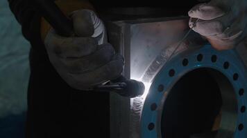 Close up of blacksmith welder in protective uniform works with metal steel and iron using a welding machine. Creative. Bright sparks and flashes, heavy industry concept. video