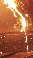 Molten metal is being poured out, producing bright sparks within a vibrant foundry environment. Stock Clip video