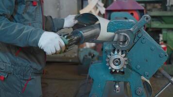Metal rolling machine working in industrial workshop. Creative. Worker at a factory by a metal rolling machine bending a steel sheet. video
