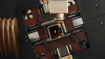 Industrial Laser cutting the edge of a square shaped pipe. Creative. Automated Industrial machine, close up view. video
