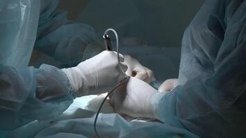 Close up of hands of surgeons team during operation with surgical laparoscopy instruments. Action. Team of surgeons at work in a hospital. video