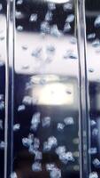 An Artistic Abstract Bubble Reflection onto a Liquid Surface with a Variety of Elements. Media video