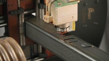 Automatic cnc laser cutting machine working with metal bar with many sparks at factory. Creative. Metalworking, industrial, equipment, technology and manufacturing concept. video