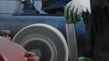 Polishing of steel parts in factory with rotating machine. Creative. Polishing of steel part on rotating machine. Polishing machine with metal part for assembly at factory video