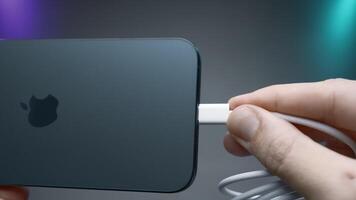 China, Beijing - September 15, 2023.Wire type C in new iPhone. Action. USB-C connector in new iPhone model 15 pro. Flagship in world of iPhones with new Type C charging connector in model 15 pro video