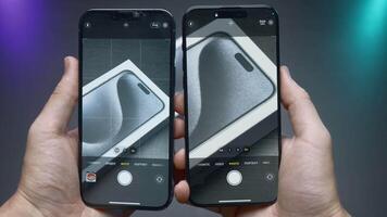 China, Beijing - September 15, 2023. Close-up of iPhone screens in comparison of cameras. Action. Comparison of camera shooting with zoom in iPhones 14 and 15 pro. iPhone screens with camera zoom video