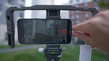China, Beijing - September 15, 2023. Holder for shooting with stabilization for phone. Action. Professional stabilizer for phone and shooting. Samsung Stabilizer with new iPhone 15 pro for video