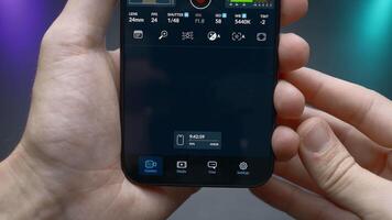 China, Beijing - September 15, 2023. Setting up camera of new iPhone 15 pro. Action. Man professionally adjusts camera in new iPhone 15 pro. Program settings of camera parameters on iPhone 15 pro video