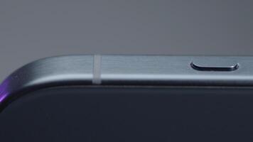 USA, New York - September 15, 2023. Close-up design of case of new iPhone. Action. Stylish design of new iPhone 15 pro max on isolated background. Button on side of new iPhone 15 pro video