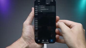 China, Beijing - September 15, 2023. Settings of new iPhone 15 pro. Action. Close-up of man setting up new iPhone 15 pro. Software and interface settings in new iPhone 15 pro video