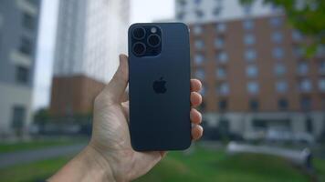 China, Beijing - September 15, 2023. Man holds new 15 iPhone in hand. Action. Newest 15 iPhone pro max. New model of iPhone 15 pro from Apple in your hands video