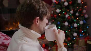 Close up of a man drinking tea late at night. video