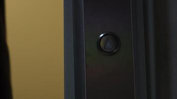Elevator lift button and person. Concept. Close-up of elevator button with opening doors and person. Man on elevator with call button video