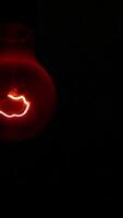 An Illuminated Light Bulb Set Against a Dark Background Creating a Striking Visual Contrast. Stock Clip video