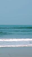 The soothing and tranquil ocean waves gently lap against the shore on a sunny day. Stock Clip video