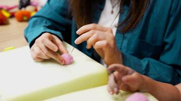 Participants create colorful felt ornaments through needle felting activities video