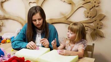 Crafting soft toys with a child at a creative workshop in autumn video