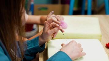 Crafting colorful felted characters during a workshop at a local studio video