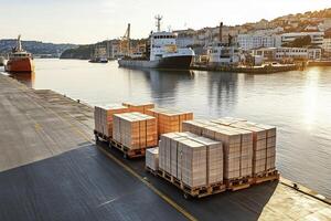 A busy harbor with cargo ships docked, and a forklift transporting goods on the pier. photo