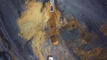 A stunning aerial view showcasing a massive mining excavation site with heavy machinery at work. Stock Clip video