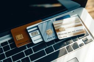 A display of diverse credit cards placed on a laptop keyboard, symbolizing the future of online payments and digital transactions photo