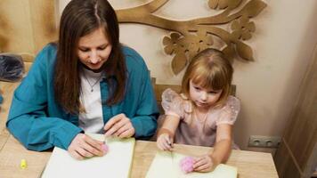 Crafting with care. A mother and daughter making art at home in winter video