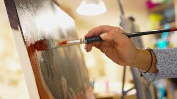 Creating a beautiful painting in a cozy art studio on a sunny afternoon video