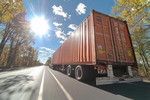 A semi-truck hauling a large shipping container down a highway, under a bright blue sky. photo