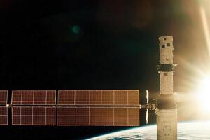 A satellite orbits Earth, bathed in golden sunlight, embodying advanced space exploration and sustainability envisioned photo